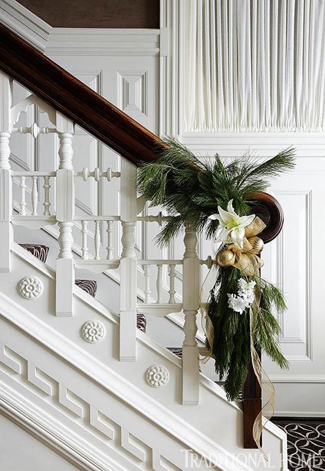 Pretty Christmas Staircases | This Gold & White Christmas Swag is simple yet elegant. it does not distract from the ornate woodwork. 