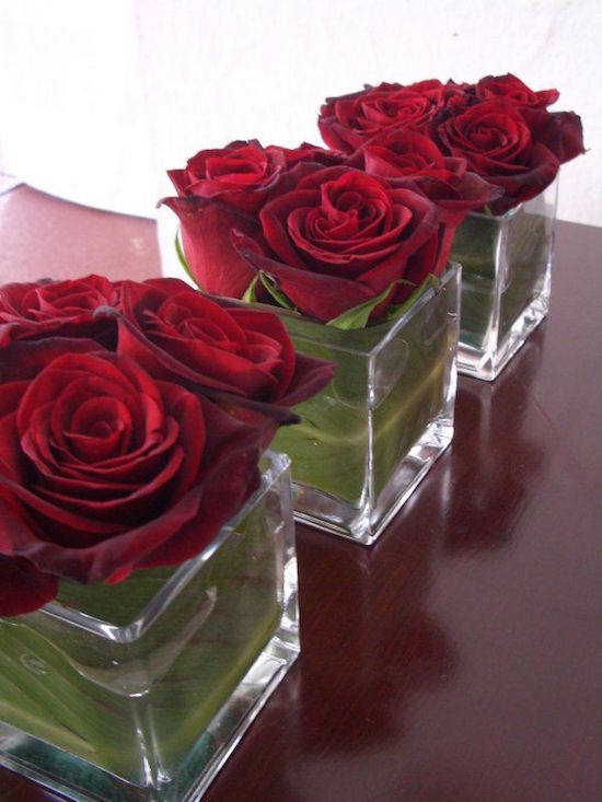 Short Red Rose Valentine Centerpieces - Love the leaf lined vase! Low centerpieces are perfect for a dinner party so guests can see each other. Read the post for more Valentine's Day Party Decorations
