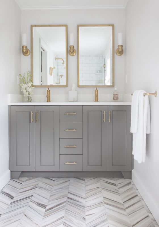 Beautiful white and gray bathroom with gold accents. The gold really adds warmth to the room.