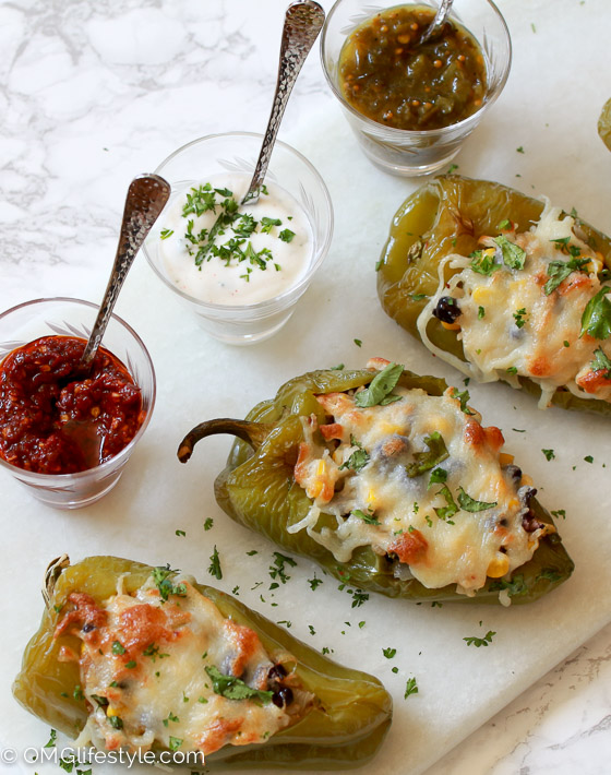 Stuffed Pablano Peppers garnished with chopped cilantro and a trio of sauces