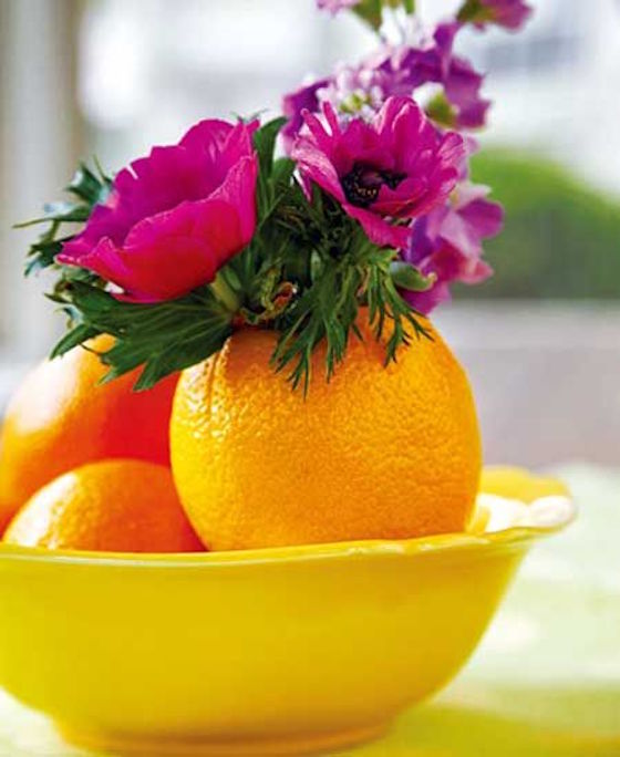 Use a hollowed orange as a mini vase