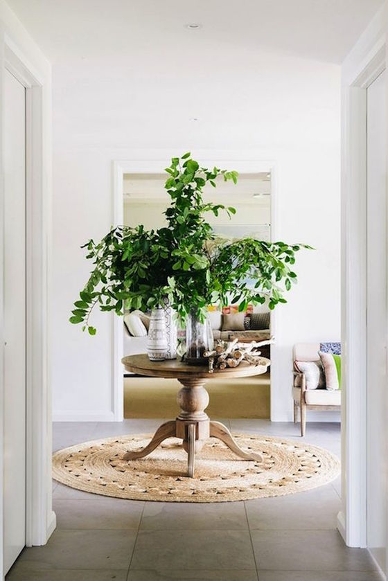 Love this center hall table from Savor Home. The green branches on this table add life to the room! See more on the blog.