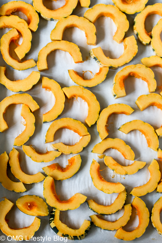 Place delicata squash on a baking sheet lined with parchment paper