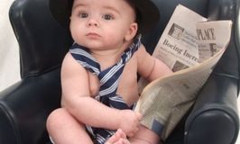 Little man reading the paper